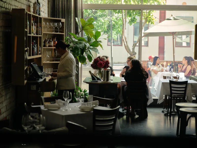 Dining room at Cutler & Co in Fitzroy, curved banquettes and low lighting.