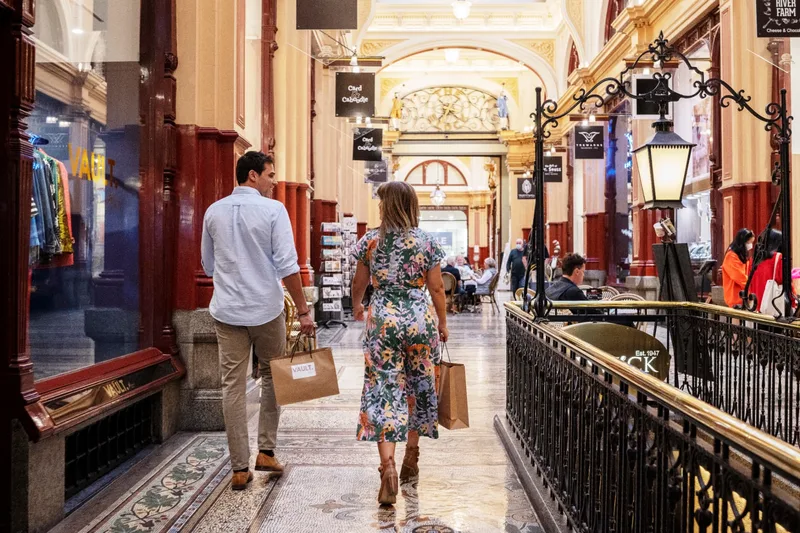 Two shoppers walking through the tiled arcade of the Block Arcade in Melbourne